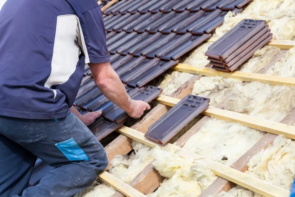 Un Couvreur Pose Des Tuiles Sur Le Toit